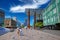 Dutch shopping square street with modern architecture buildings in city center, blue summer sky