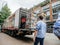 Dutch street scene with large truck unloading multiple drinks on the platform to