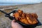 Dutch street seafood, deep fried cod fish fillet with garlic sauce called in Netherlands kibbeling and North sea beach on