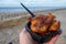 Dutch street seafood, deep fried cod fish fillet with garlic sauce called in Netherlands kibbeling and North sea beach on