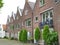 Dutch Style Dark Brown Brick Wall with White Decoration Houses