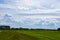 Dutch Summer landscape with green grass and cloudy blue sky