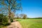 Dutch walking trail along lush green fields and small forests