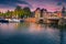 Dutch water canals with moored boats at sunset, Amsterdam, Netherlands