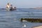 Dutch waterside Vlissingen with cargo ship sailing close to coast