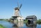 Dutch windmill at a canal on a sunny summer day