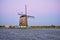 Dutch windmill near a lake with earth shadow in the background