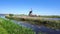 Dutch windmill over river waters