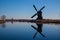 Dutch windmill reflecting in the canal water in Kinderdijk Holland