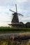 Dutch windmill, small village in North Brabant, mill and corn fields on sunset