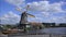 Dutch windmill working on canal in Holland, Netherlands