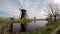 Dutch windmills in Kinderdijk reflect in the water, time lapse