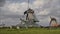 Dutch windmills working on canal in Holland, Netherlands