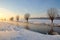 Dutch winter landscape with snow and low sun