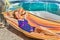 Dutch woman relaxing in hammock near pool