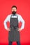 On duty in kitchen. Hipster cafe concept. Man with beard cook hipster apron. Hipster chef cook red background. Bearded