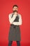 On duty in kitchen. Hipster cafe concept. Man with beard cook hipster apron. Hipster chef cook red background. Bearded