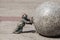 Dwarf pushing a granite ball in Wroclaw