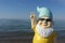 Dwarf with sunglasses seaside makes peace sign