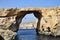 DWEJRA, GOZO, MALTA - Oct 11, 2014: A man cliff diving, jumping off the Azure Window into the sea below, at Dwejra Gozo