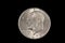 A Dwight Eisenhower American one dollar coin isolated on black