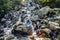 Dwoista Siklawa - Dual waterfall - split cascade waterfall at the Mnichowy Potok creek seen from the shore of Morskie Oko lake,