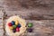 Dyed quail eggs in a nest on wooden background.