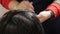 Dyeing female hair in a dark color in a hairdressing salon. hairdresser hand applied coloring pigment in the skin of the