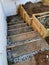 DYI construction of a garden stairs near basement wall of a residential building