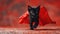 Dynamic black kitten with a flowing red cape.
