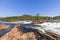 Dynamic cascades of the Namsen River in Namsskogan, Trondelag, Norway, with foreground focus on textured riverside stones