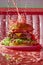 Dynamic Cheeseburger Splash on Vibrant Pink Background Fast Food Concept, Juicy Burger with Flying Ingredients