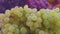 Dynamic close up of white and red grapes on a local farmers market with moving camera