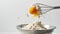 Dynamic cooking process captured mid-action in a kitchen. egg breaking over flour, image ideal for culinary content