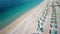 Dynamic fly over the Oludeniz beach with sun loungers and turquoise sea