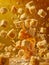 Dynamic Freeze Motion of Caramel Candy Pieces Splashing in Sweet Golden Syrup on a Warm Background