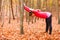 Dynamic girl stretching in forest.