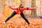 Dynamic girl stretching in forest.