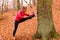 Dynamic girl stretching in forest.