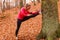 Dynamic girl stretching in forest.