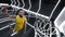 Dynamic image of young man, basketball player in yellow uniform, throwing ball into basket in jump at 3D basketball