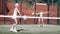 Dynamic old woman playing Padel Tennis in pairs in the open air tennis court