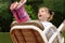 A dynamic outdoor portrait of a smiling little girl on a swing