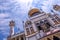 Dynamic perspective, low angle view of islamic building Sultan Mosque or Masjid Sultan against sunny bright blue sky with clouds,