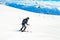 Dynamic picture of a skier on the piste in Alps. Woman skier in the soft snow. Active winter holidays, skiing downhill in sunny