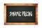 DYNAMIC  PRICING text written on wooden frame school blackboard