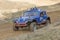 Dynamic shot of blue off road car in terrain