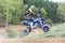 Dynamic shot of young quad rider jumping