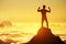 A dynamic silhouette of a person with fists up in the air on a mountain top