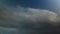 Dynamic sky timelapse showing dramatic cloud movement, changing light conditions. Meteorological phenomena above urban